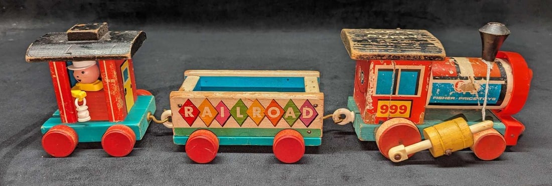 Vinage Huffy Puffy Fisher Price Vintage Wood Train: Vintage Huffy Puffy Fisher Price Vintage Wood Train. The engine is approx 8" x 5 1/2" x 4 1/2". The railroad car is approx 7 3/4" x 4 1/2" x 2 1/2". The caboose is approx 5"