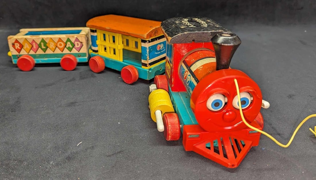 Vintage Wooden Fisher Price Huffy Puffy Toy Train: Vintage Wooden Fisher Price Huffy Puffy Toy Train. 3 Part Wooden Train. The engine is approx 8" x 5" x 4 1/4". The "Railroad" Car is approx 7" x 4 1/2" x 2 1/2" and the