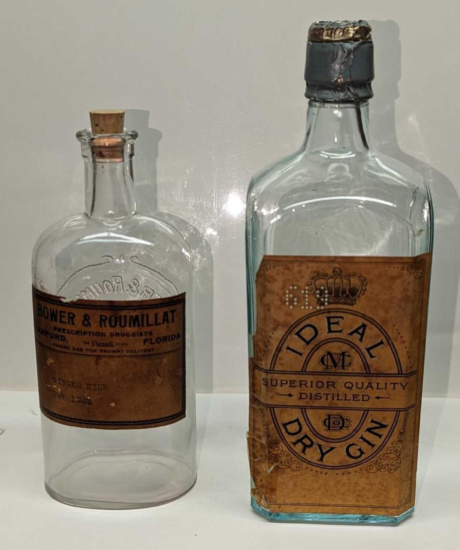 Ideal Superior Quality Distilled Dry Gin & Ginger Wine Bottles: Ideal Superior Quality Distilled Dry Gin & Ginger Wine Bottles. This lot includes: (1) Ideal Superior Quality Distilled Dry Gin Glass Bottle. This empty bottle is approx 3 1/4" x 3" x 9 3/