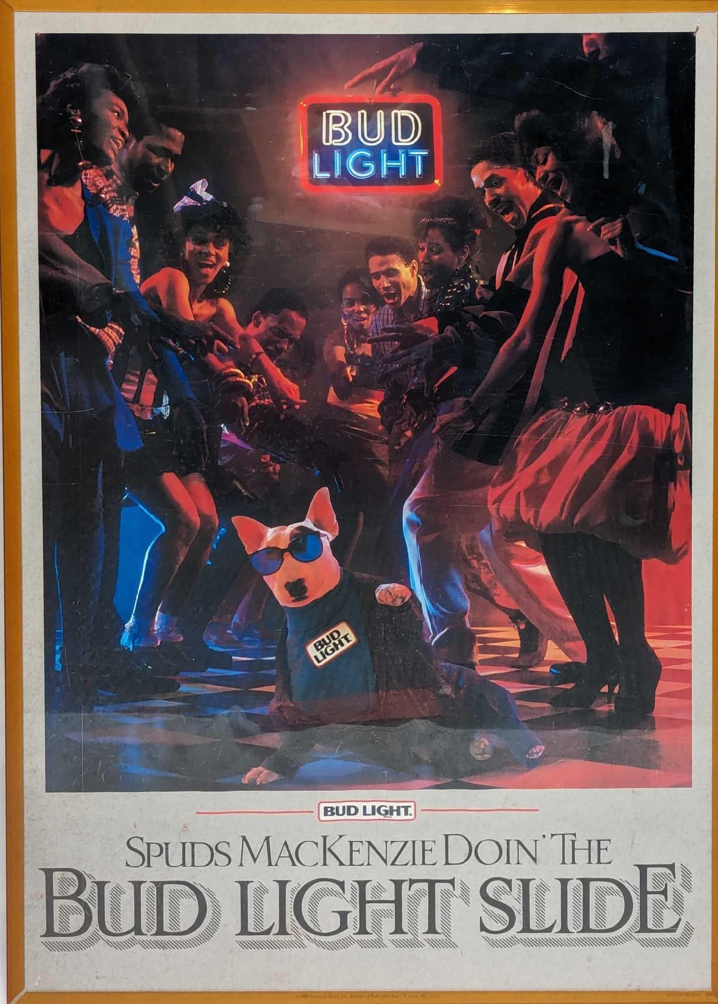 Vintage Bud Light Spuds MacKenzie Bud Light Slide Poster: Vintage Bud Light Spuds MacKenzie Bud Light Slide Poster. The original poster is encased in an acrylic sleeve with a cardboard backing. The sleeved poster is approx 20" x 1/4" x 28" and it