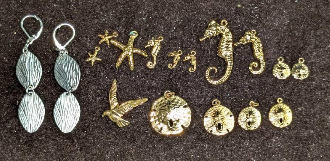 Vintage Gold Plated Sea Themed Pendants And Silver Tone Earrings: Vintage Gold Plated Sea Themed Pendants And Silver Tone Earrings. This lot includes a group of gold-plated sea-themed pendants for both necklaces and charm bracelets. These start from itty bitty starf
