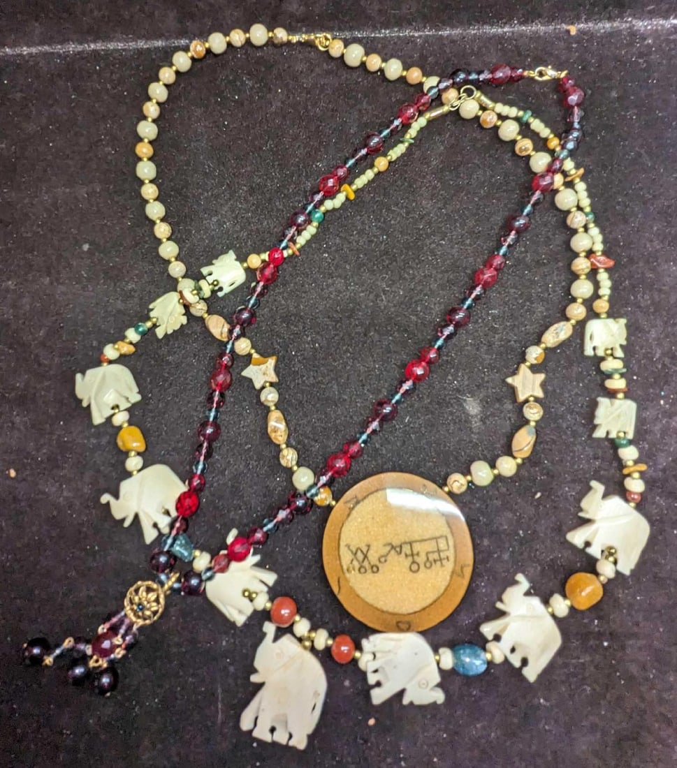 3 Camel Bone Lee Sands Jasper Burgundy Beaded Necklaces: 3 Camel Bone Lee Sands Jasper Burgundy Beaded Necklaces. This lot includes: (1) Camel Bone Elephant Beaded Necklace. This measures 29". (1) Lee Sands Jasper Necklace With Medallion Pendant. This m