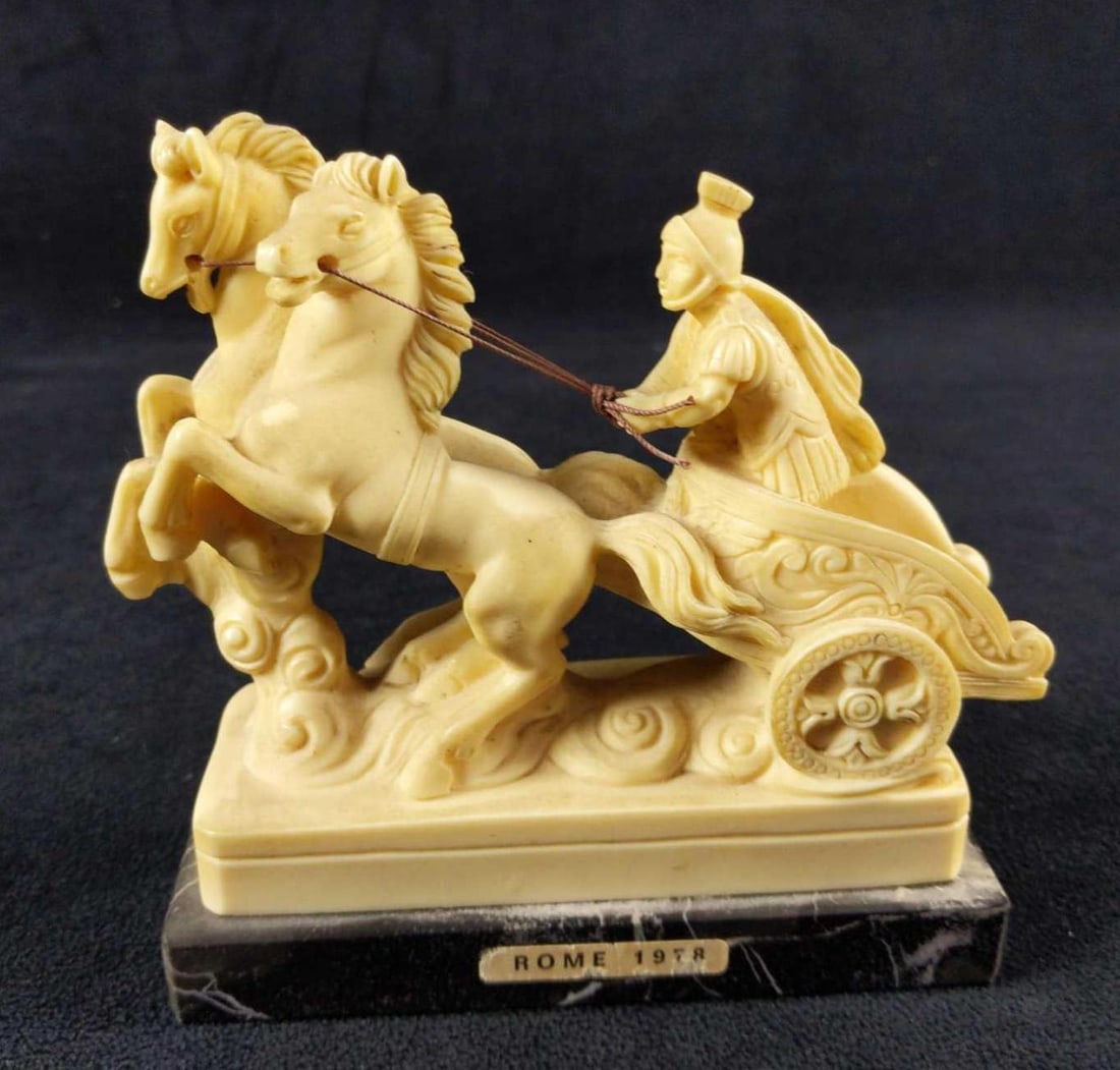 Vintage Roman Soldier Chariot By Gino Ruggeri: Vintage Ricordo Di Roma Roman Soldier Chariot By Gino Ruggeri. Made of white resin which is mounted on marble. Is dated on the side "1978". Figurine is approx 4 5/8" x 2" x 5" and 