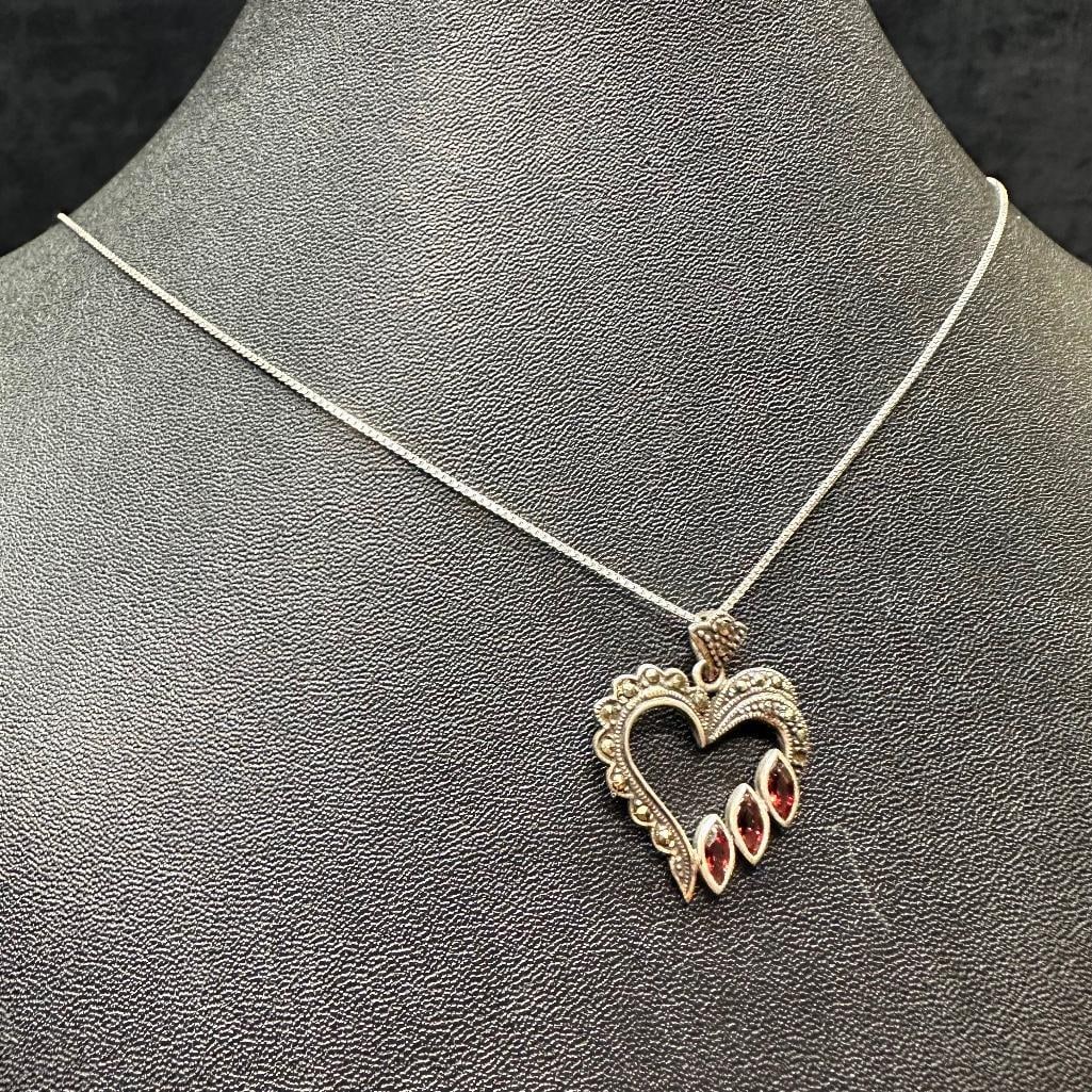 Sterling Silver Garnet Marcasite Heart Pendant: This piece of jewelry has been tested and researched prior to listing. Please view all our pictures they are part of our description. DETAILS: Metal - Sterling Silver Color - Silver Stones - Marcasite