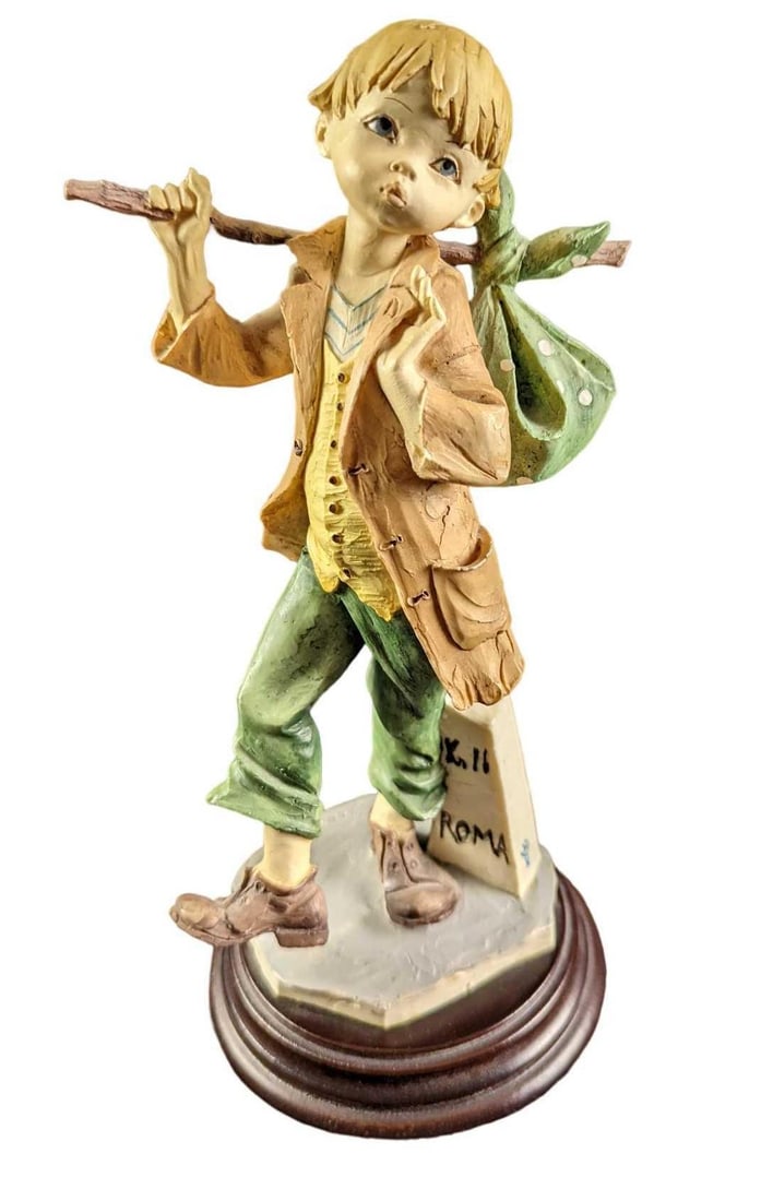 Capodimonte Porcelain Traveling Child Figurine: Capodimonte Porcelain Traveling Child Figurine. The figurine is approx 5" x 4 5/8" x 10" and it weighs 1.48lbs. The figurine has both the Capodimonte and the artist's signature on the