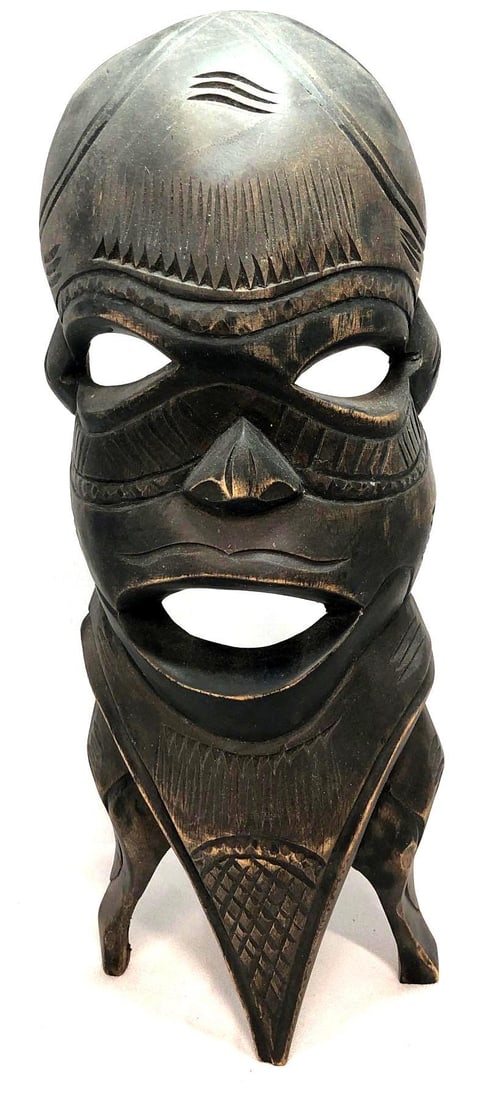Handmade African Carved Wood Tribal Mask: Tribal Mask from Mozambique, Africa. Handmade Carved Wood. Item does not have a hook for hanging on wall - can stand on flat surfaces. The mask is approximately 13-1/2" x 5-1/2" x 3" and w