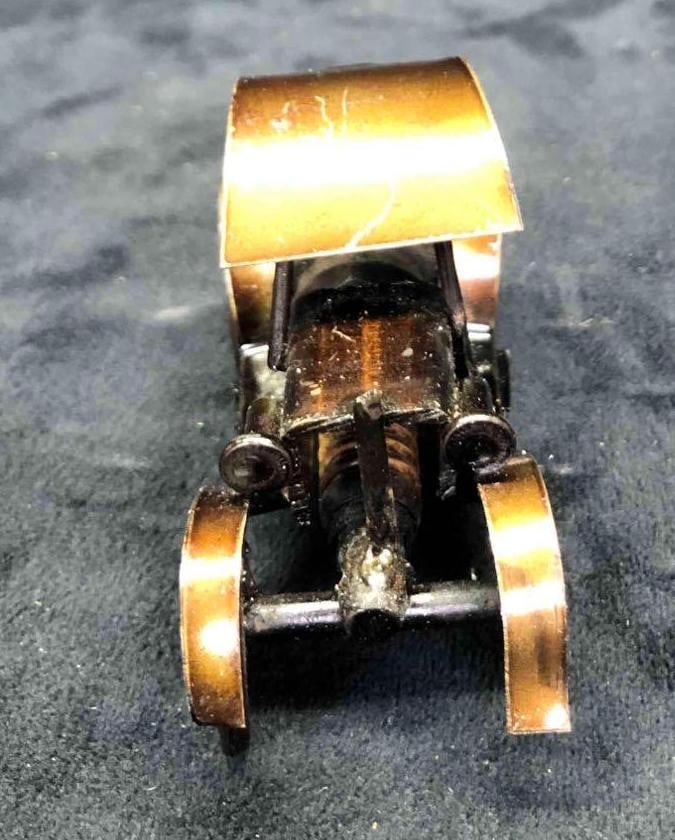 Handmade Metal & Recycled Spark Plug Miniature Vintage Car Sculpture: This lot contains a handmade metal and recycled spark plug miniature vintage car sculpture. The car is covered in a coat of glaze for shine and protection. It is approx 3 1/2" x 1 1/4" x 2"