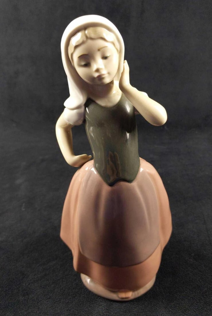 Nao Lladro Porcelain Peasant Girl With Veil: Nao hand made Porcelain Peasant Girl With Veil figurine. The figurine is approx 5" x 4" x 10" and is in good, unused condition with some wearing on the bottom.