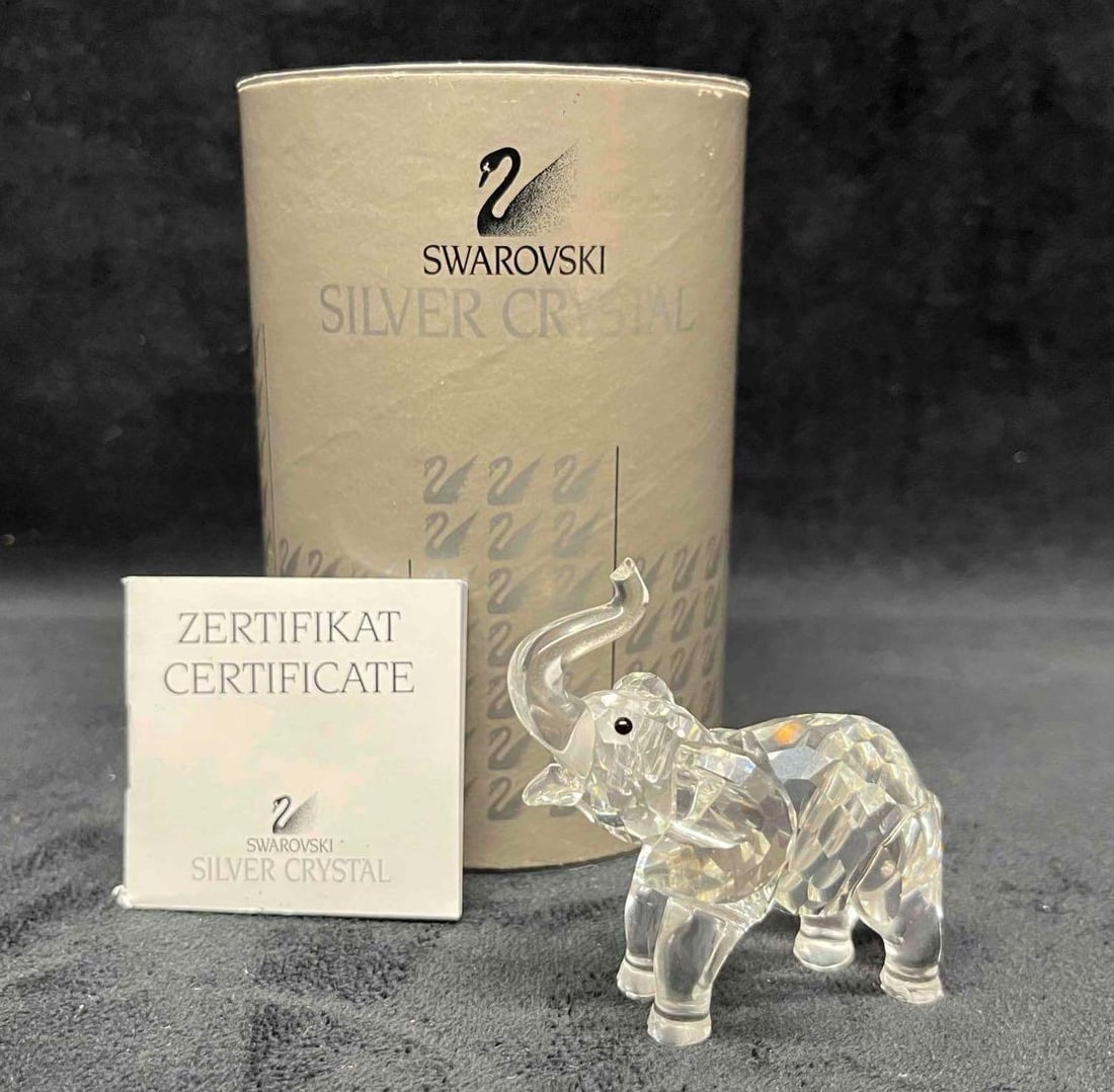 Swarovski Baby Elephant figurine #7640 In Original Box With Certificate: This lot contains a Swarovski Baby Elephant figurine #7640 In Original Box With Certificate. Approx weight and measurements are listed below. Overall the Swarovski Baby Elephant is in excellent used c
