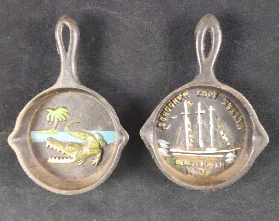 Vintage 2 John Wright Cast Iron Mini Frying Pans: Vintage John Wright Cast Iron Mini Frying Pan. From the 1940s and 1950s. This lot includes: (1) Schooner Lucy Evelyn At Beach, Haven New Jersey. (1) Menacing alligator near the ocean and palm tree.