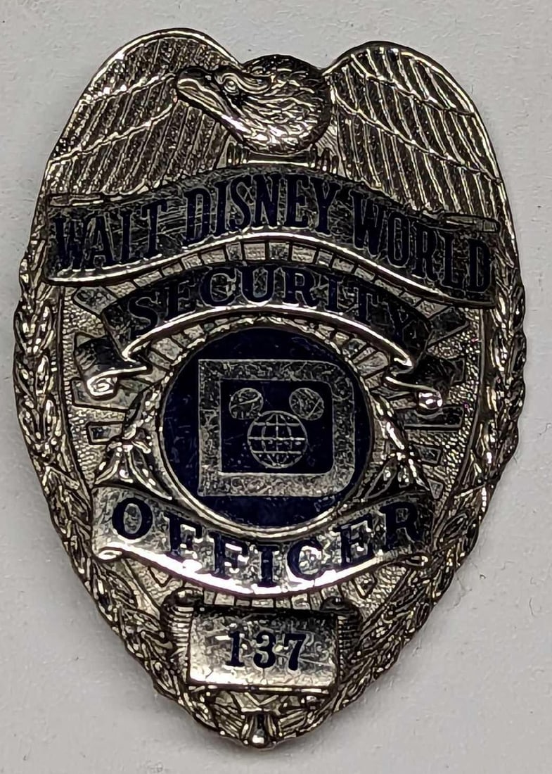 Early 1980s Disney World Security Metal Badge 137: Early 1980s Disney World Security Metal Badge 137. Is approx 2" x 1/4" x 2 3/4" and it weighs under one pound at 0.12lb. The metal badge is in a good, vintage condition with some wear and 