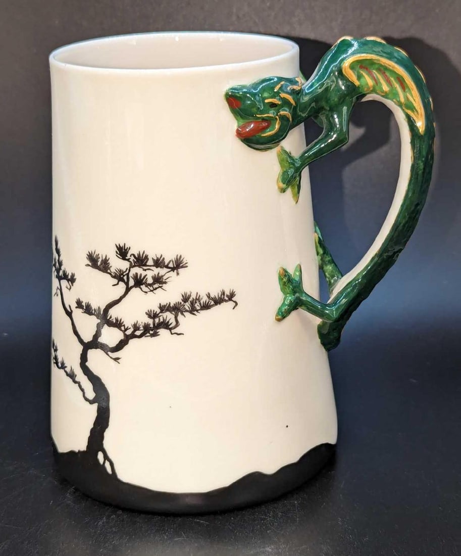 Vintage Belleek Stein With Applied Green Lizard Handle: Vintage Belleek Stein With Applied Green Lizard Handle. This is approx 5" x 4" x 5 3/4" and it weighs 0.85lb. The ceramic mug has some small black spots. Please see the images as they are 