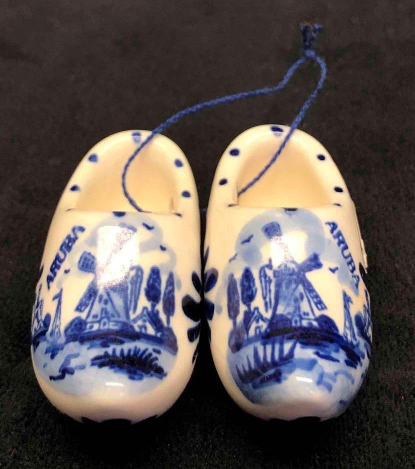 Vintage Aruba Miniature Shoes Ornament: This lot contains a vintage Aruba miniature shoes ornament. The ornament is made of glass and is decorated with blue and white. It is approx 2 1/2" x 1" x 1/2" and weighs about 0.1lbs. Ove