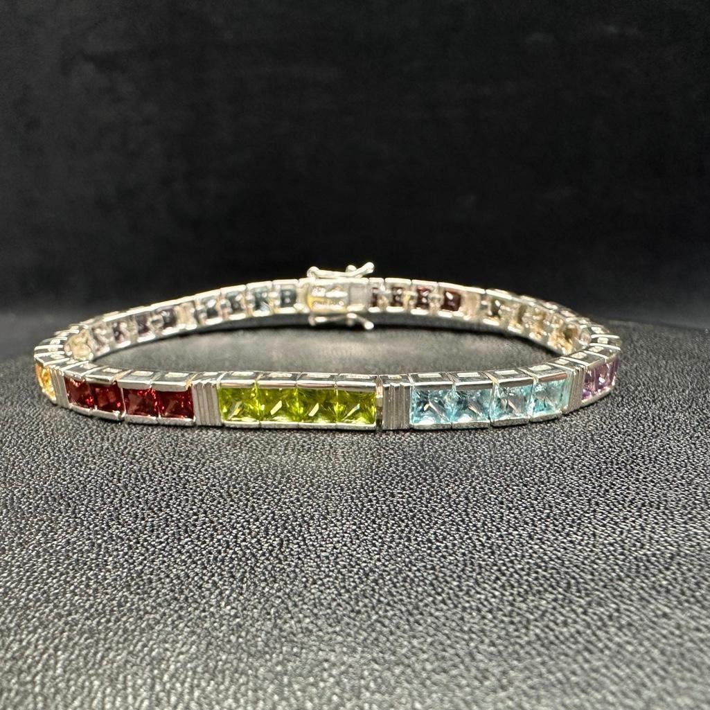 Sterling Silver Rainbow Tennis Bracelet: This piece of jewelry has been tested and researched prior to listing. Please view all our pictures they are part of our description. DETAILS: Metal - Sterling Silver Color - Silver Stones - amethyst,