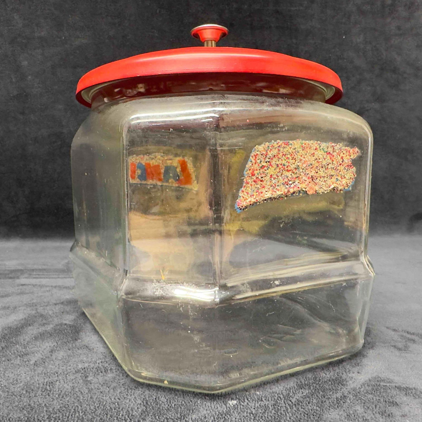 Vintage LANCE Cracker Glass Store Counter Jar Container Original Metal Lid: Vintage LANCE Cracker Glass Store Counter Jar Container Original Metal Lid. This Lance collectible glass jar has eight sided and red metal lid. On two sides there is a glitter logo. Under the metal li