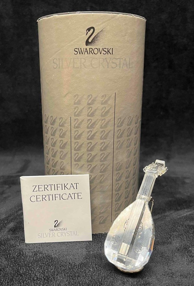 Swarovski Crystal Melodies Lute Figurine #7477 In Original Box With Stand & Certificate: This lot contains a Swarovski Crystal Melodies Lute Figurine #7477 In Original Box With Stand & Certificate. Approx weight and measurements are listed below. Overall the Swarovski Lute Figurine is