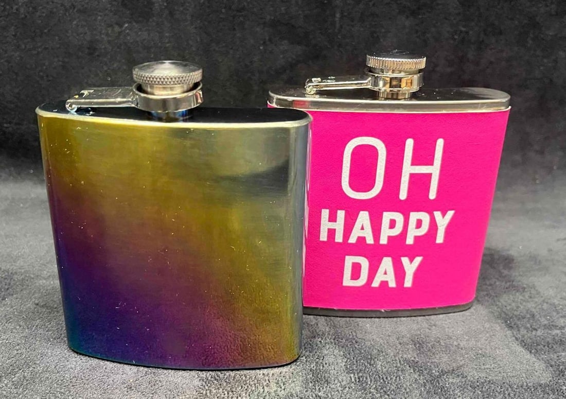 Two Drinking Flasks Rainbow & Hot Pink Oh Happy Day: This lot contains Two Drinking Flasks Rainbow & Hot Pink Oh Happy Day. Each flask is approx 4" x 1" x 4 1/2". Total weight together is about 0.4lbs. Each flash holds 6oz. Overall the f
