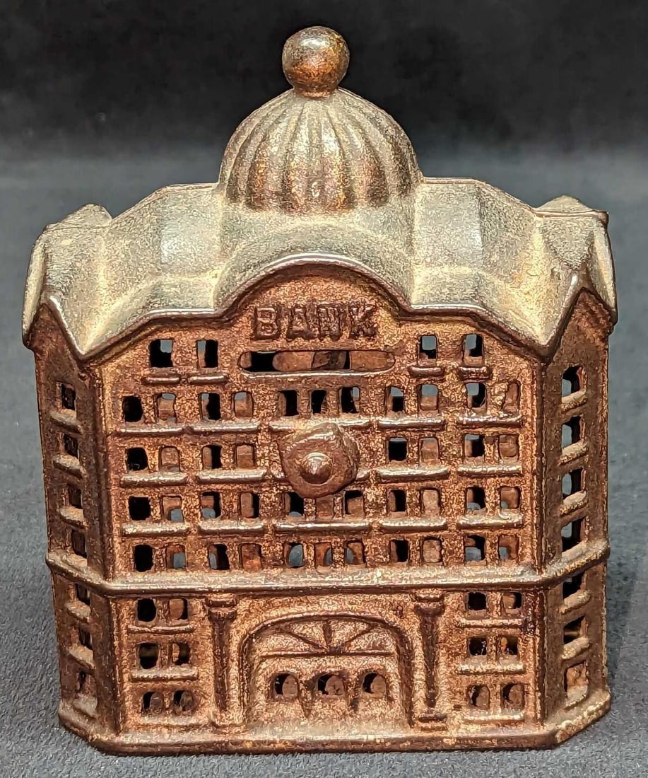 Vintage Cast Iron Bank Building Bank: Vintage Cast Iron Bank Building Bank. Is approx 4 1/4" x 2 1/2" x 5" and it weighs 1.41lb. The bank has some wear and light surface rust.