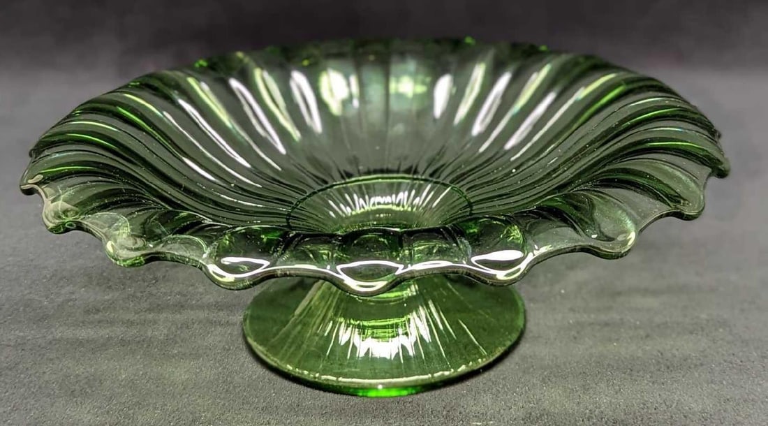 Vintage Heisey Green Glass Pedestal Bowl: Vintage Heisey Green Glass Pedestal Bowl. This is approx 11" x 11" x 4" and it weighs 2.38lb. The glass has some light scratches and small bubbles near the edge/rim.