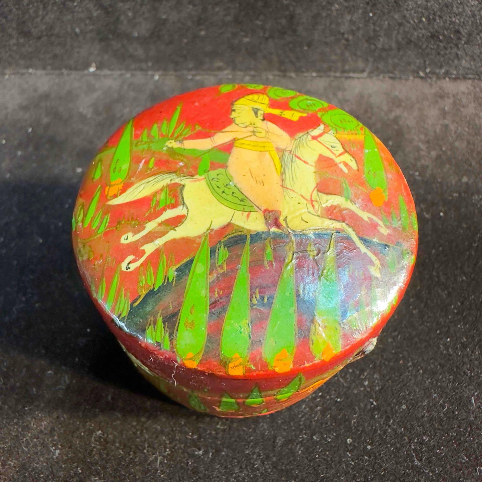 Hand Painted Wooden Pill Box Animal Art: Hand Painted Wooden Pill Box Animal Art. This unknown origin pill box features a man riding a horse on the top and animal creatures around the box. Red color on the outside with a black coloring insid