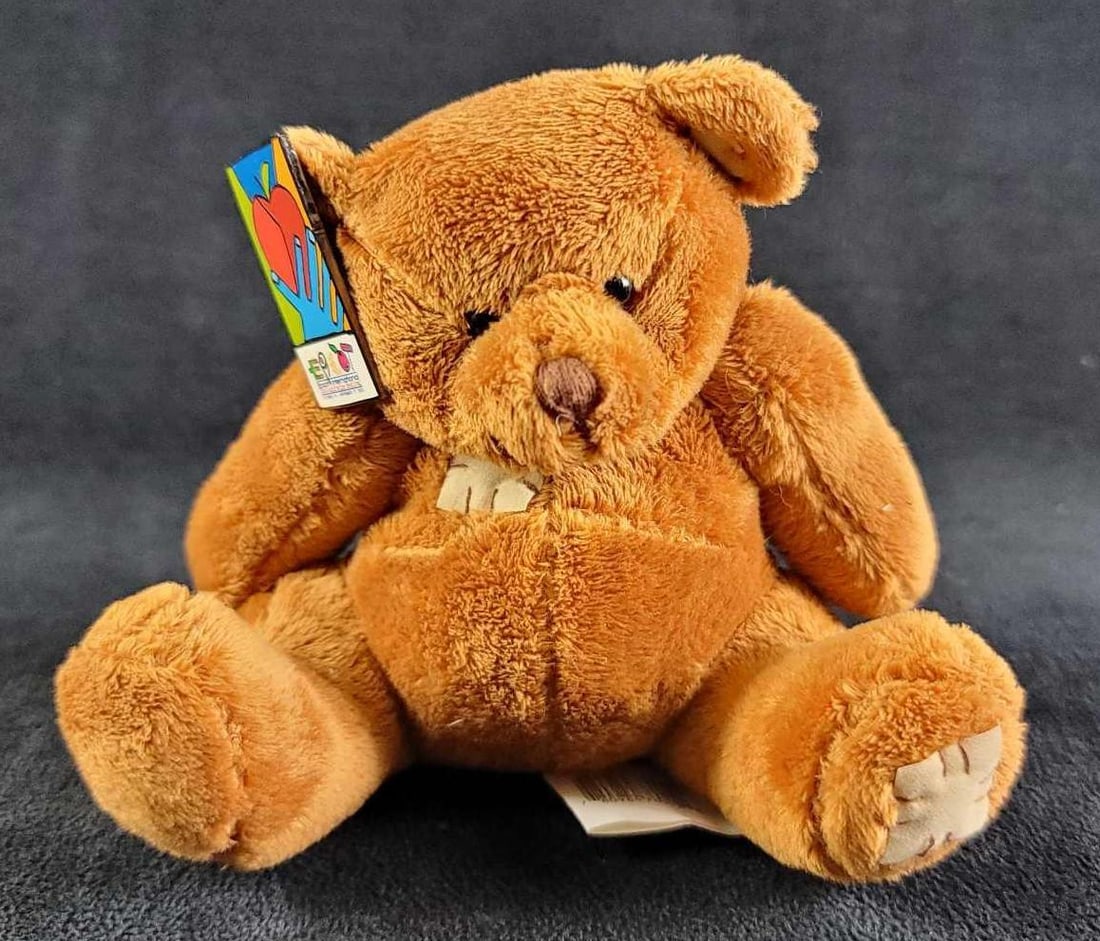 Epcot Pin Food and Wine Festival Teddy Bear: This lot contains a soft plush teddy bear, made in china, and the pin attached to the ear is Epcot's Food and Wine Festival pin for 2002. In good condition, with no known damages. Approx. measures