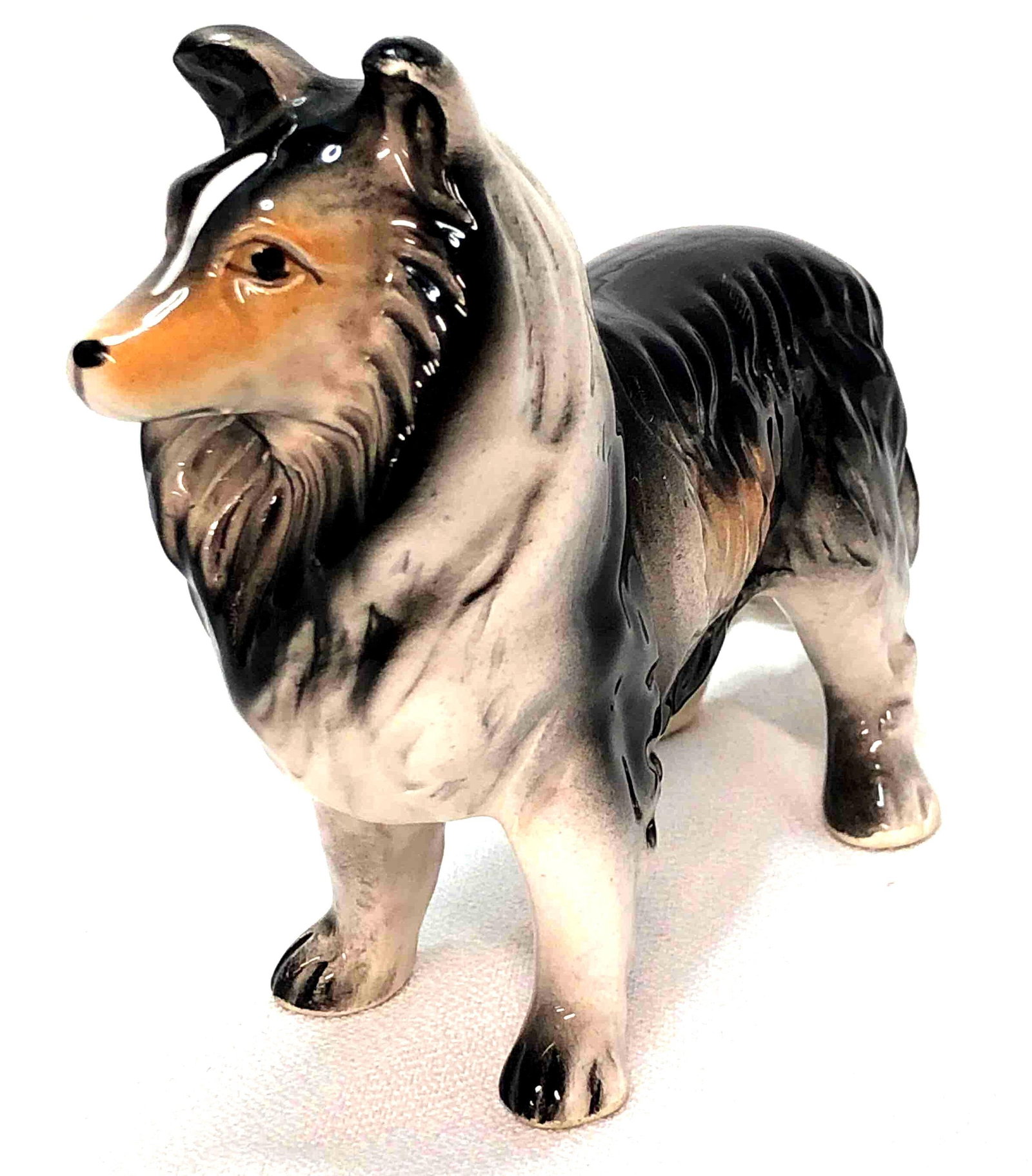 VTG MCM Porcelain Collie/ Sheltie/ Lassie Figurine: Vintage MCM Glazed Porcelain Collie/ Sheltie/ Lassie Figurine. Marked Foreign. The Vintage Dog Figurine is approximately 5" x 4" x 2" and weighs about 0.2lbs. Overall this item is in vinta