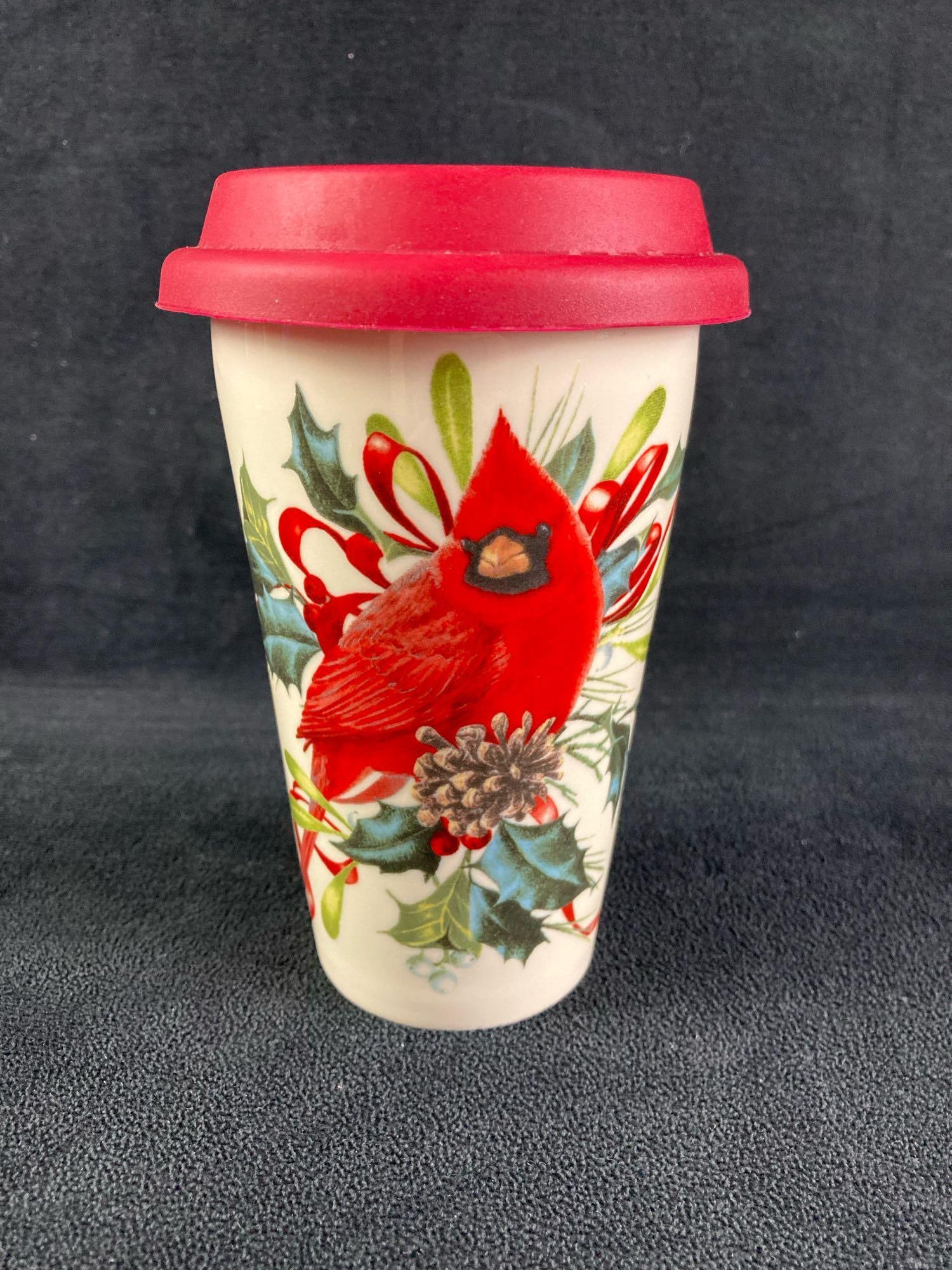 Glass Cardinal Bird Mug: Up for auction is a recent estate find, a glass cardinal cup with a rubber cover. The front has a decorative display of plants and a cardinal. This auction includes: (1) Glass Cardinal Bird Mug