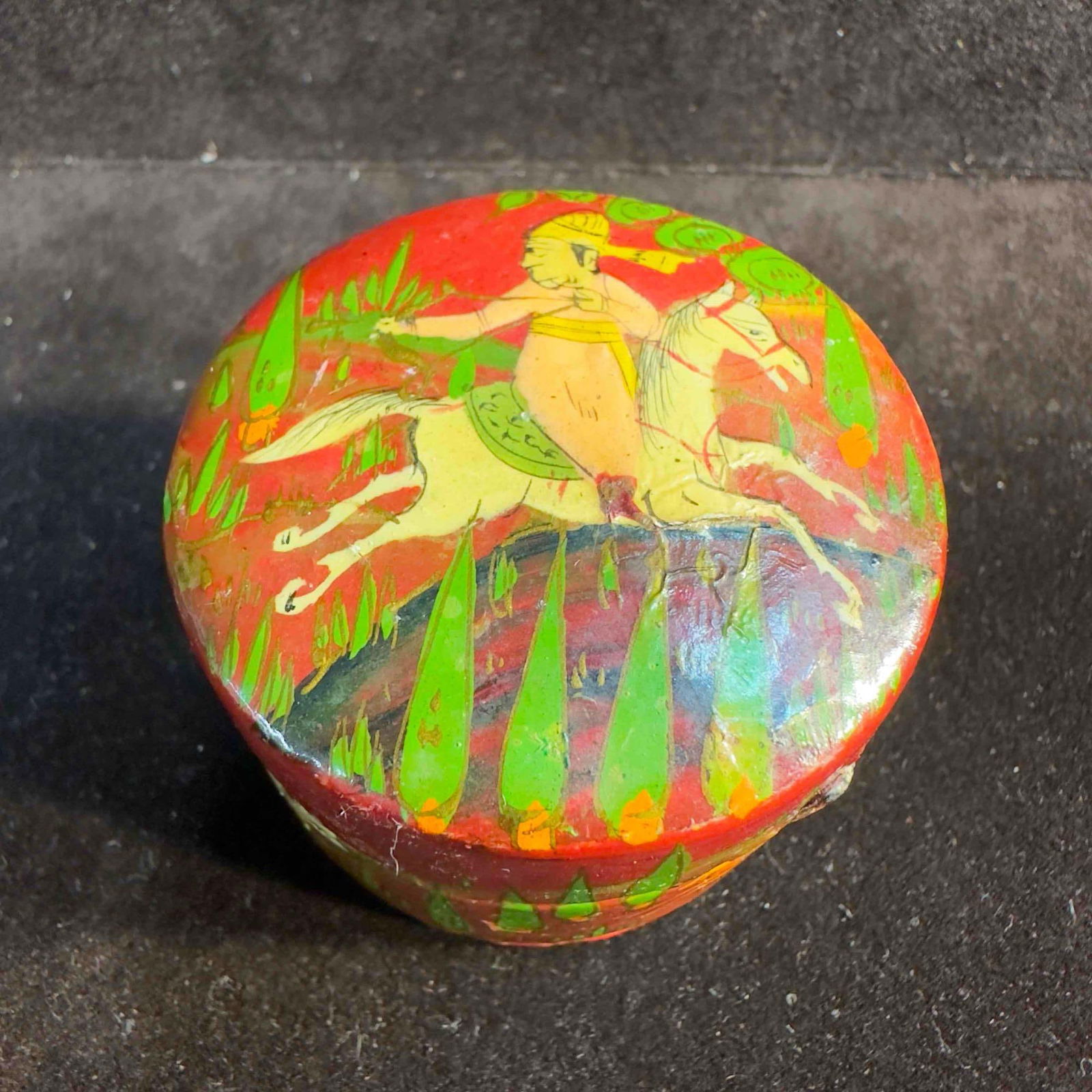 Hand Painted Wooden Pill Box Animal Art: Hand Painted Wooden Pill Box Animal Art. This unknown origin pill box features a man riding a horse on the top and animal creatures around the box. Red color on the outside with a black coloring insid