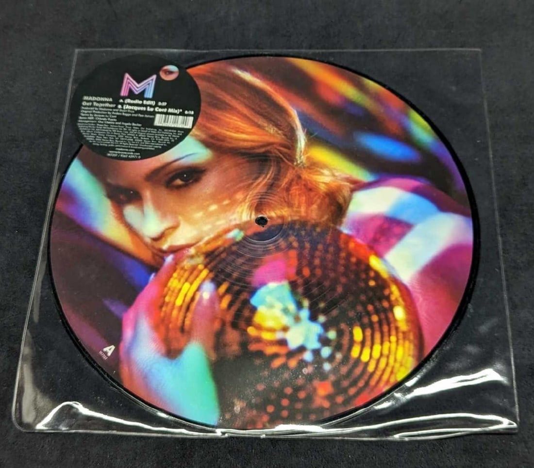Madonna Get Together Vinyl Promo Picture LP: Madonna Get Together Vinyl Promo Picture LP. This was released by Warner Bros Records in 2006. Side B has a light scratch, which should not hinder the LP from playing. This is approx 12 1/2" x 12 