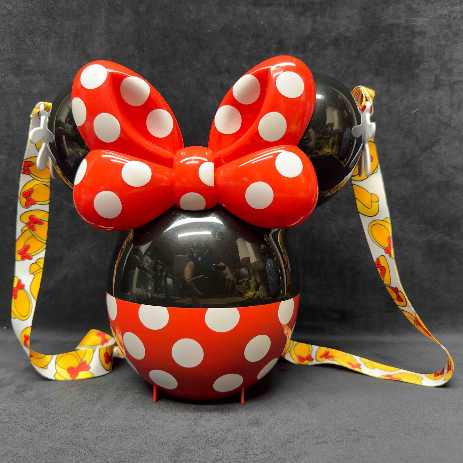 Disney Parks Minnie Mouse 90th Anniversary Popcorn Snack Bucket With Lanyard: Disney Parks Minnie Mouse 90th Anniversary Popcorn Snack Bucket With Lanyard. This collectible popcorn bucket features Minnie Mouse theme. Comes with connected lid and strap. This item is in good pre-