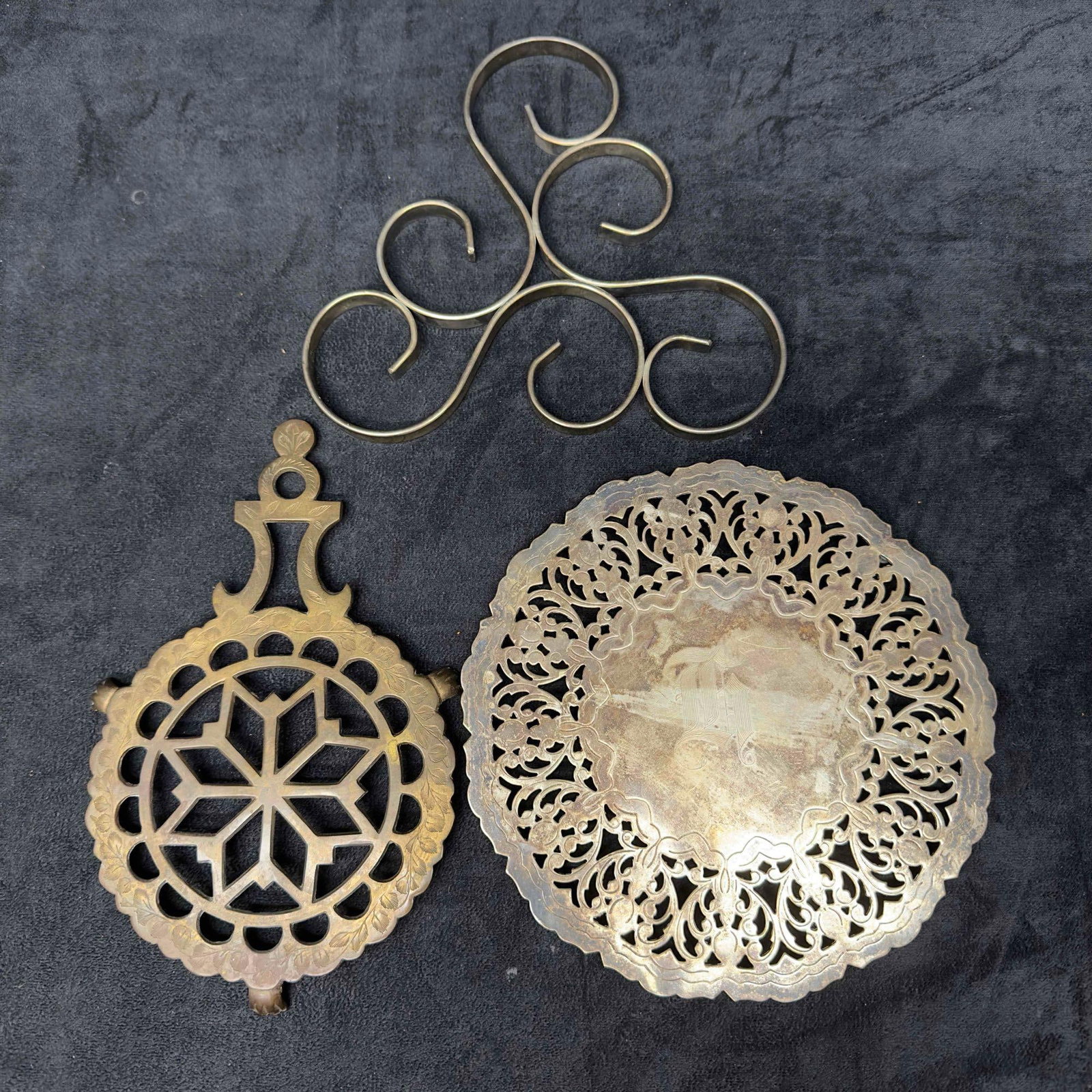 Brass Bronze Trivet Wall Hanging Decor Hot Plate Set of Three: Brass Bronze Trivet Wall Hanging Decor Hot Plate Set of Three. Each piece has a unique design with one showcasing some floral engraving. Included in this set is one silver plated hot plate with monogr