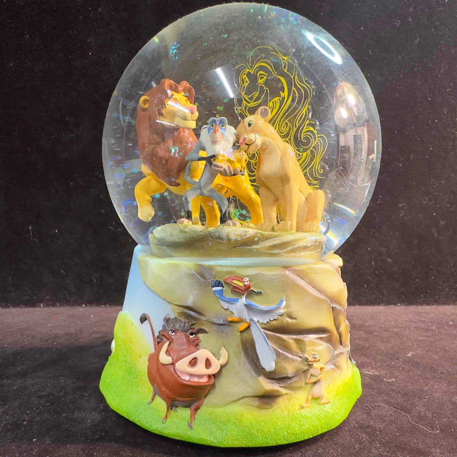 The Lion King Circle Of Life Enesco Musical Snow Globe: The Lion King Circle Of Life Enesco Musical Snow Globe. This Disney musical snow globe features The Lion King Pride Rock scene with Simba, Nala, Rafiki, Kiara, and Mustafa in the background. The music