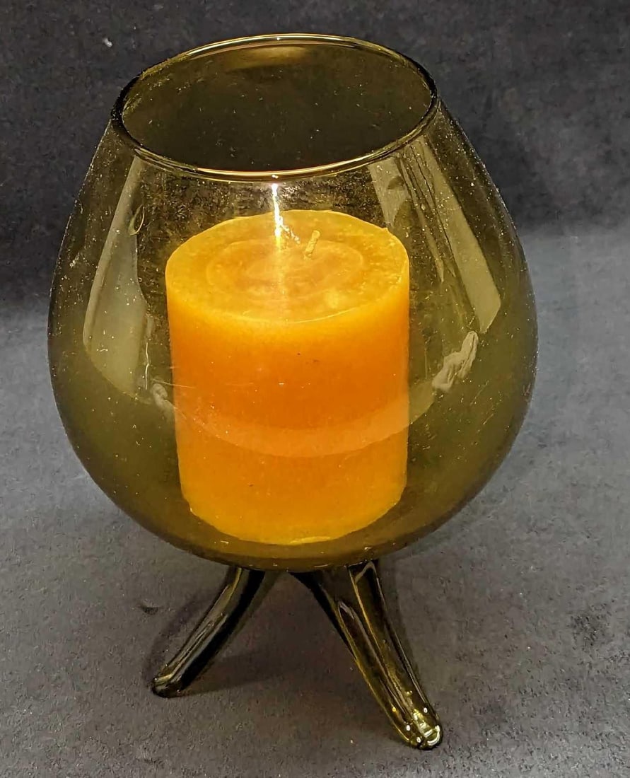 Vintage Glass Candle Holder With Candle: Vintage Glass Candle Holder With Candle. This is approx 6" x 6" x 8 3/8" and it weighs 1.55lb. The candle holder is in a good, vintage condition with some candle residue inside. Its maker 