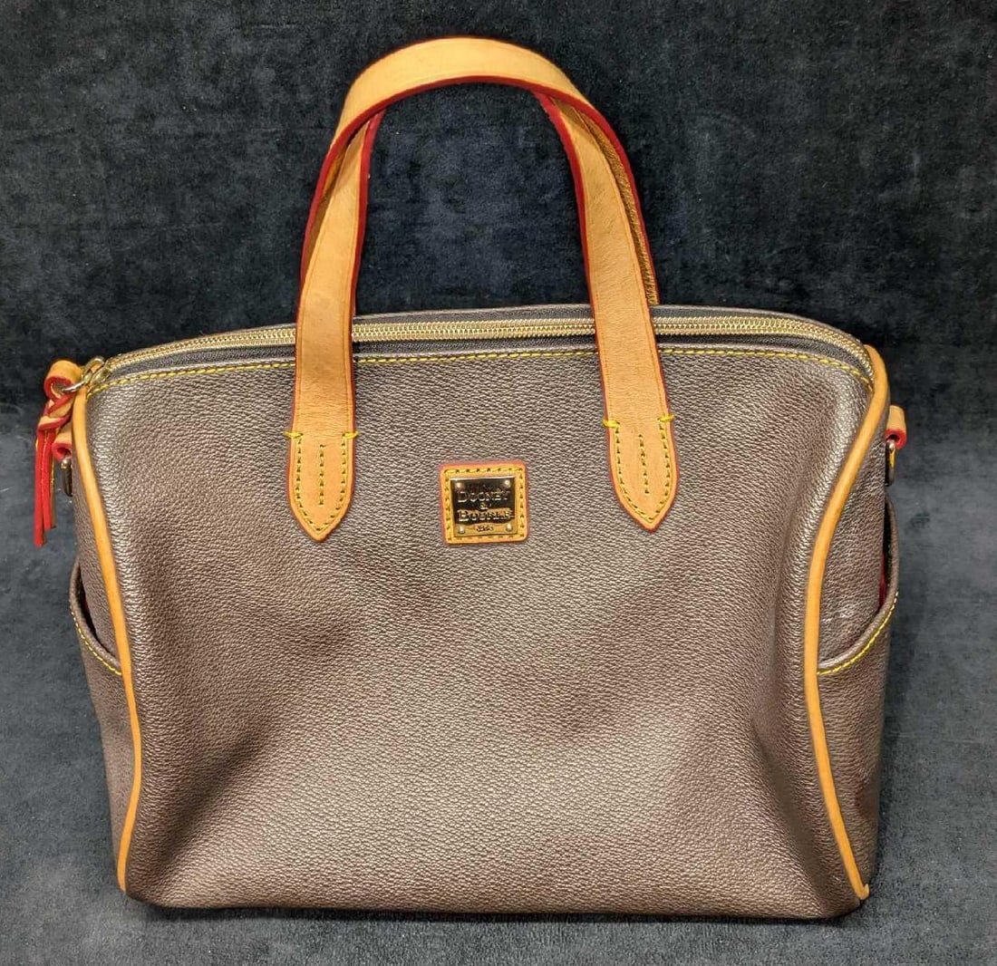 Dooney And Bourke Olivia Satchel Bag: Dooney And Bourke Olivia Satchel Bag. This is approx 12" x 7" x 9" and it weighs 1.50lb. The bag has some signs of wear inside the bag and a very small white flake on the side of the bag n
