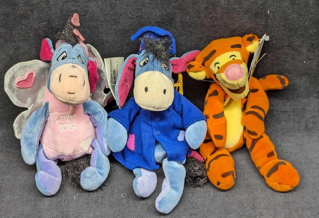 3 Disney Eeyore & Tigger Bean Bag Dolls: 3 Disney Eeyore & Tigger Bean Bag Dolls. This lot contains: (1) Tigger Bean Bag Doll. This is approx 4" x 6" x 8 1/2". (1) Lovebug Eeyore Bean Bag Doll. This is approx 4" x 4" 