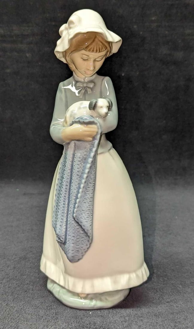 Nao Lladro Girl With Puppy Figurine: Nao Lladro Girl With Puppy Figurine. Was designed by Fulgencio Garcia and released in 1982. The figurine is approx 4" x 3" x 10" and weighs under one pound at 0.91lb. The figurine has some