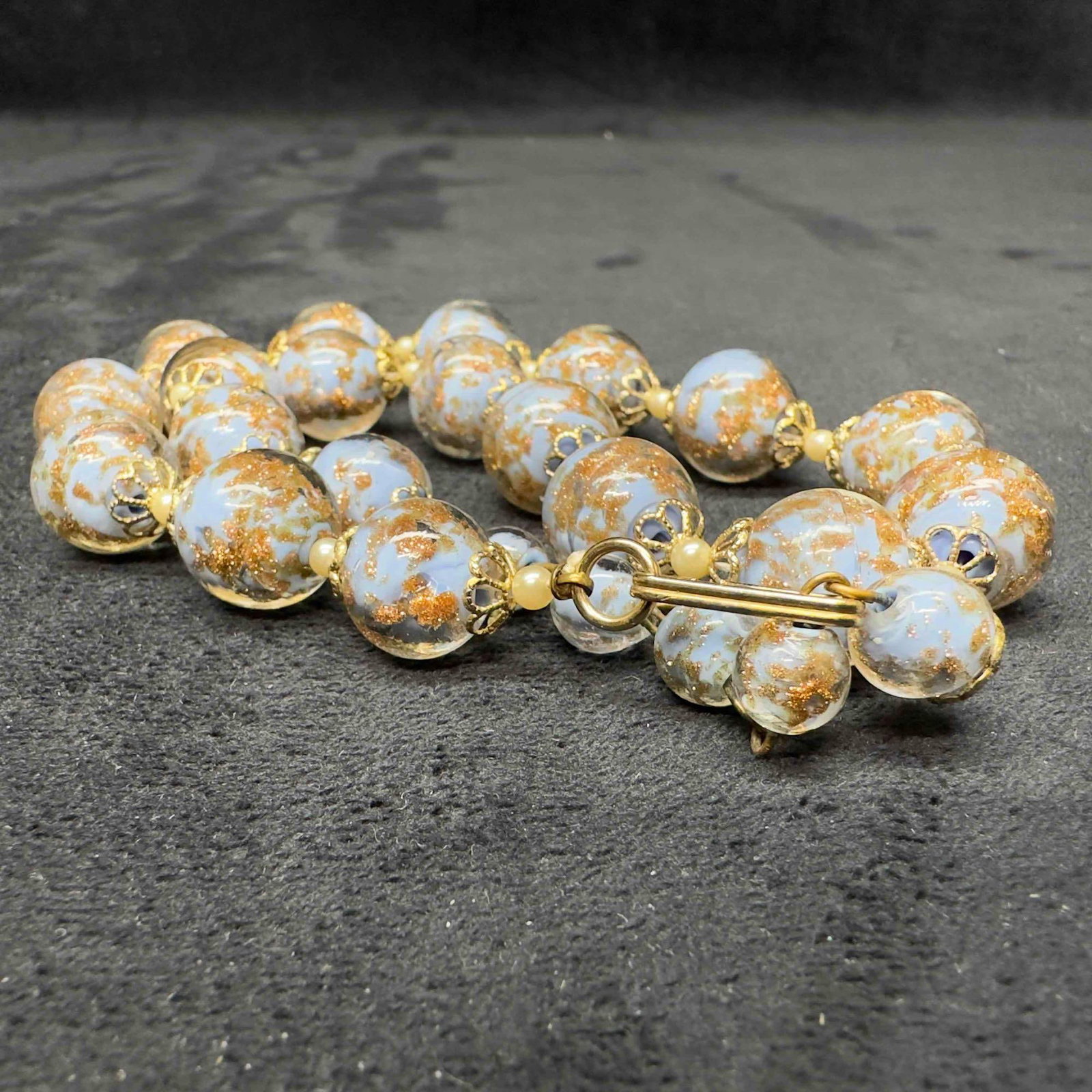Murano Venetian Art Glass Lamp Work Bead Light Baby Blue Copper Accent Beaded Necklace B53: Murano Venetian Art Glass Lamp Work Bead Light Baby Blue Copper Accent Beaded Necklace B53. Necklace with baby blue colored glass beads with beautiful designs on each. The necklace features copper col