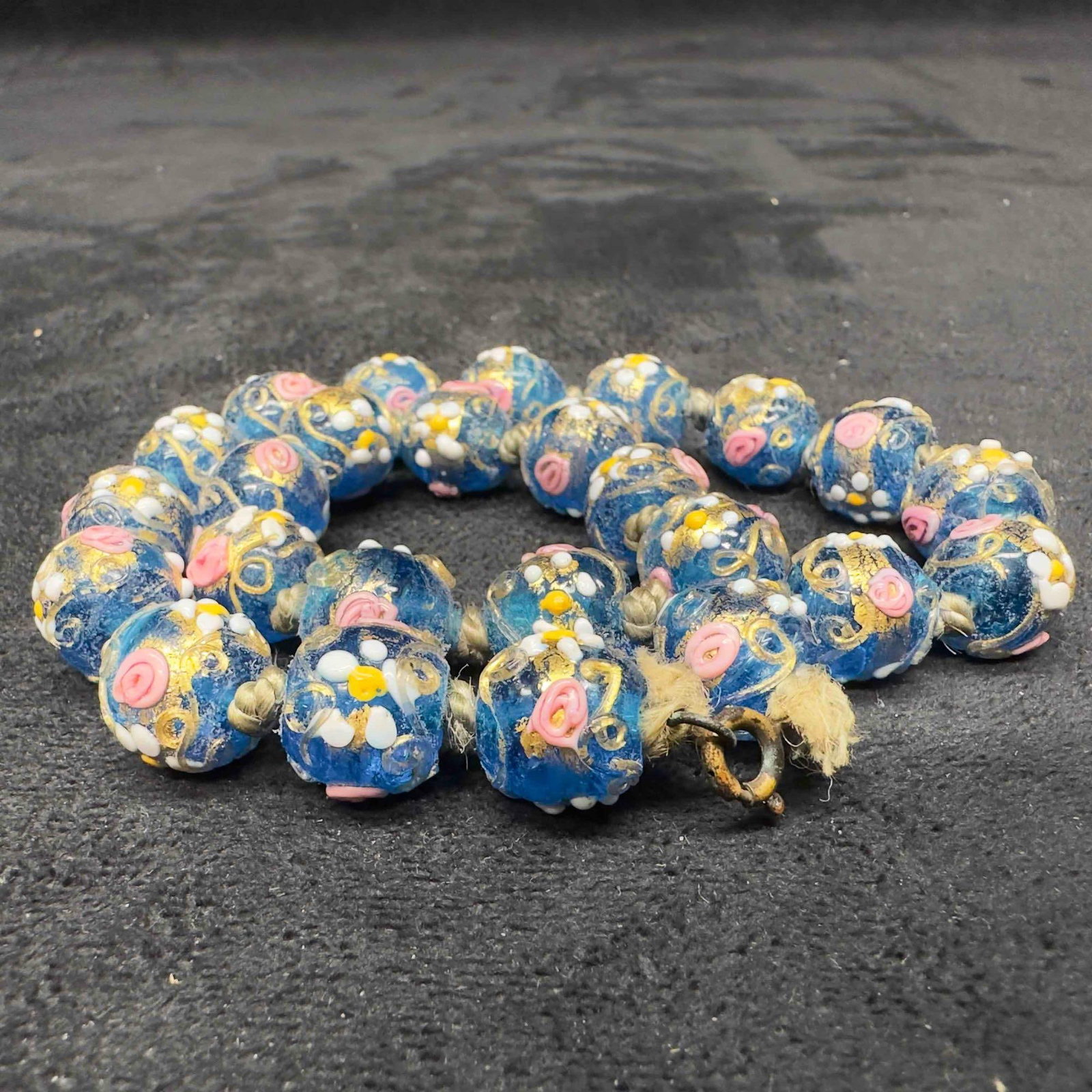 Murano Venetian Lamp Work Glass Floral Blue Round Beaded Necklace B30: Murano Venetian Lamp Work Glass Floral Blue Round Beaded Necklace B30. Necklace with blue colored glass beads with beautiful hand painted designs on each. The necklace features floral accents. The nec