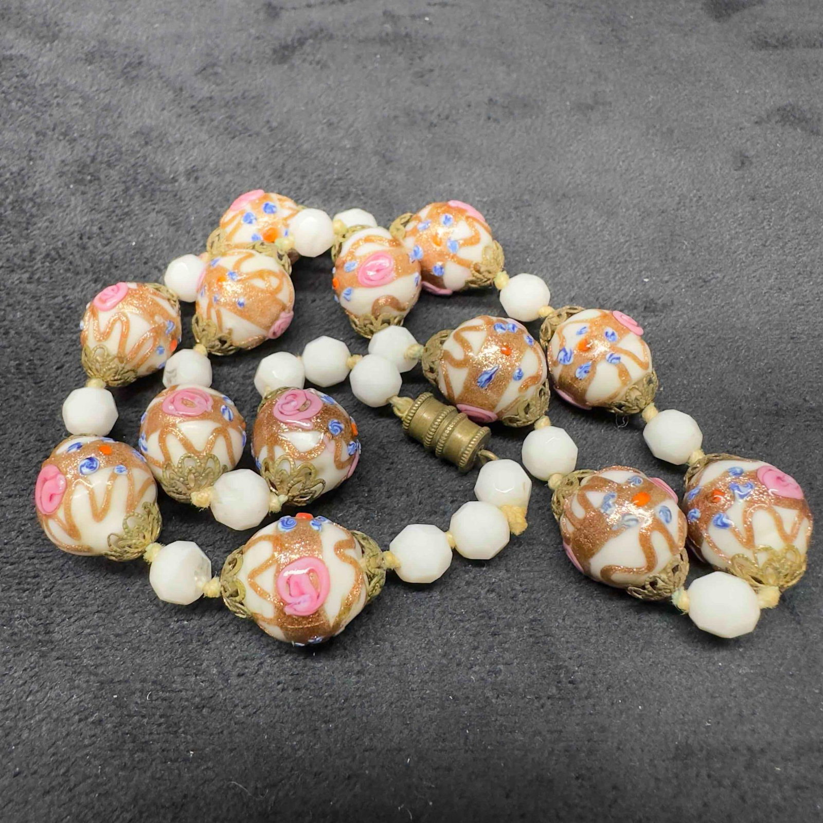 Venetian Murano Lamp Work Art Glass Bead White Beaded Floral Necklace B51: Venetian Murano Lamp Work Art Glass Bead White Beaded Floral Necklace B51. Necklace with white colored glass beads with beautiful designs on each. The necklace features copper and floral accents. The 