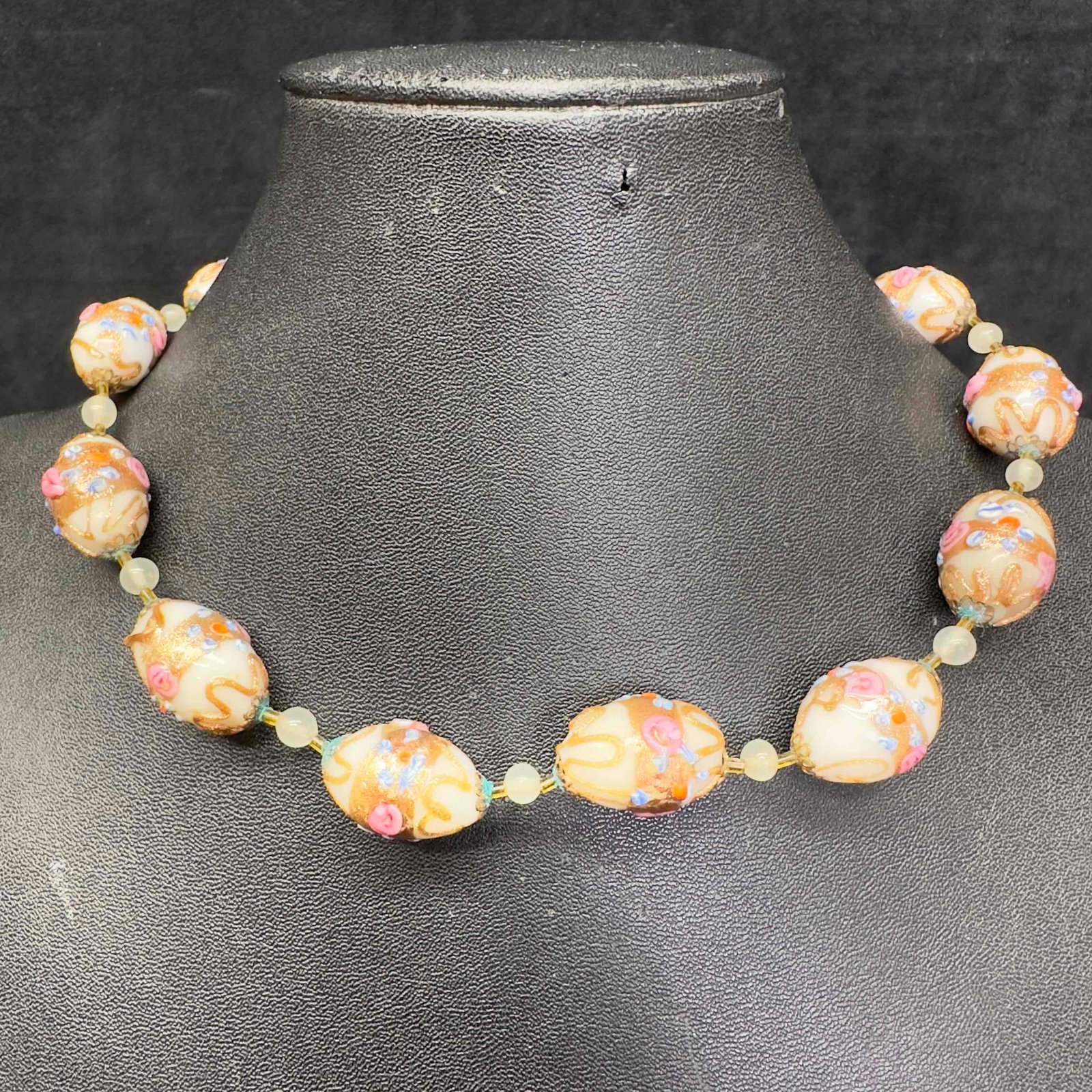 Venetian Murano Lamp Work Glass Oval White Bead Necklace: Venetian Murano Lamp Work Glass Oval White Bead Necklace. Necklace with white colored glass beads with beautiful hand painted designs on each. This item is in good pre-owned, previously displayed cond