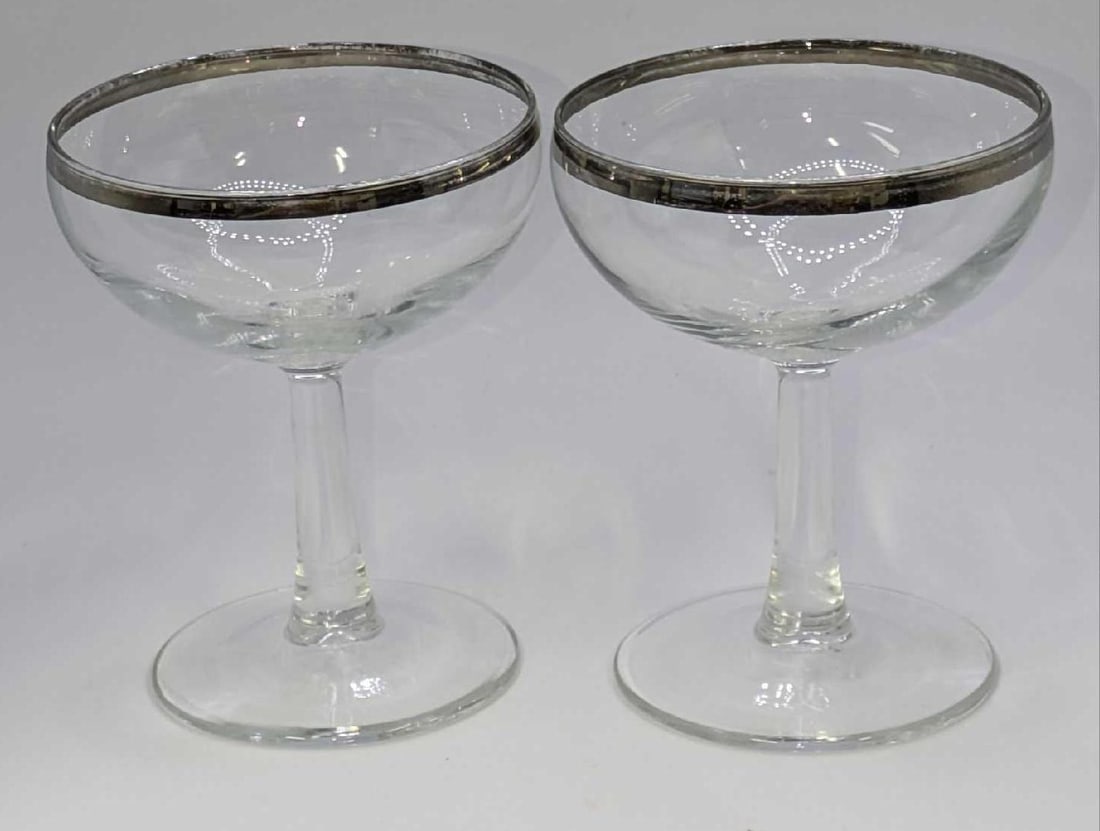 2 Vintage French Silver Rimmed Champagne Coupe Glasses A: 2 Vintage French Silver Rimmed Champagne Coupe Glasses A. Each glass is approx 3 1/2" x 3 1/2" x 4 1/4" and it weighs 0.52lb. The glasses have some wear on the trim and no chips or cracks.