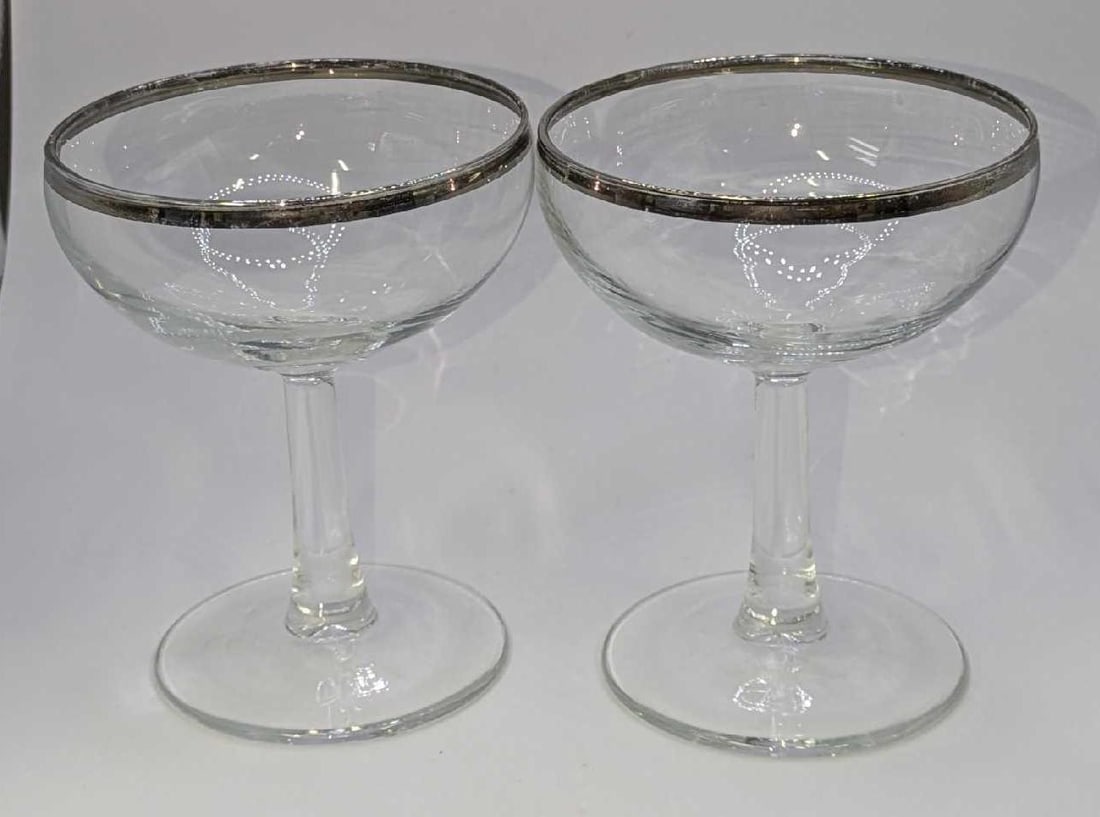 2 Vintage French Silver Rimmed Champagne Coupe Glasses C: 2 Vintage French Silver Rimmed Champagne Coupe Glasses C. Each glass is approx 3 1/2" x 3 1/2" x 4 1/4" and it weighs 0.50lb. The glasses have some wear on the trim and no chips or cracks.