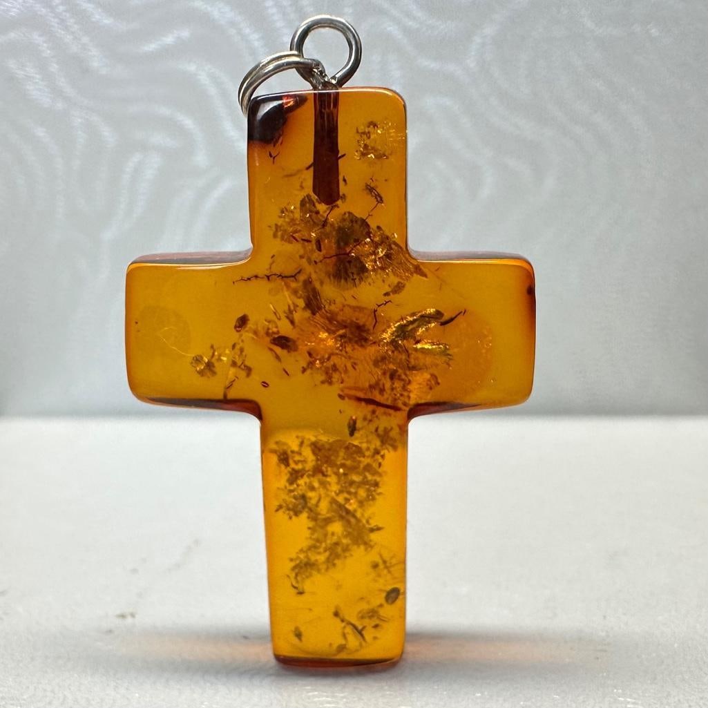 Sterling and Amber Cross Pendant: This piece of jewelry has been tested and researched prior to listing. Please view all our pictures they are part of our description. DETAILS: Metal - Sterling Silver Color - Silver Stones - Amber Hal