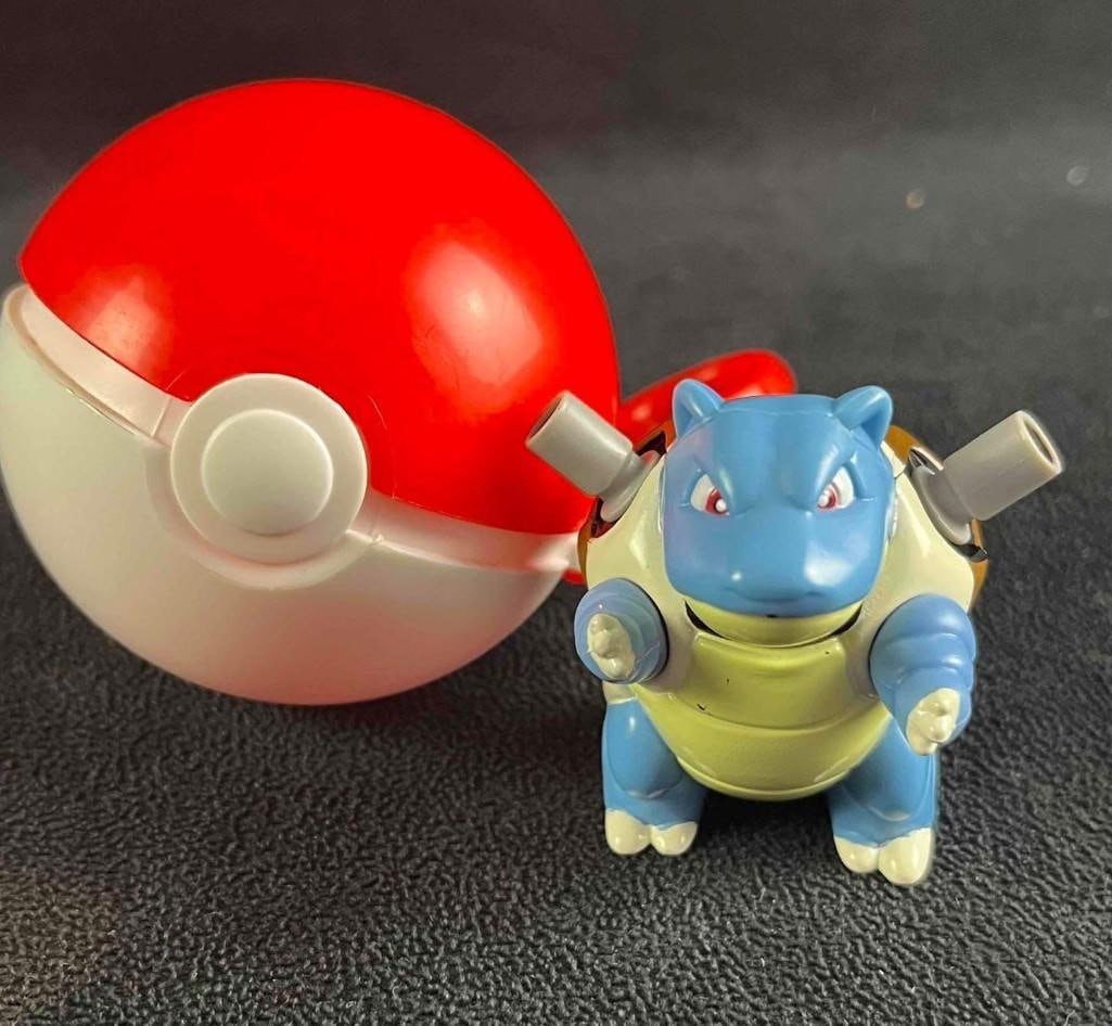 Pokémon Ball Keychain and Pokémon Toy Blastoise: Pokémon Ball Keychain and Pokémon Toy Blastoise. This is an early 2000s Pokemon toy keychain. The key chain is a poke ball with a Pokemon toy inside. The items are in good condition. This 3 1/2"