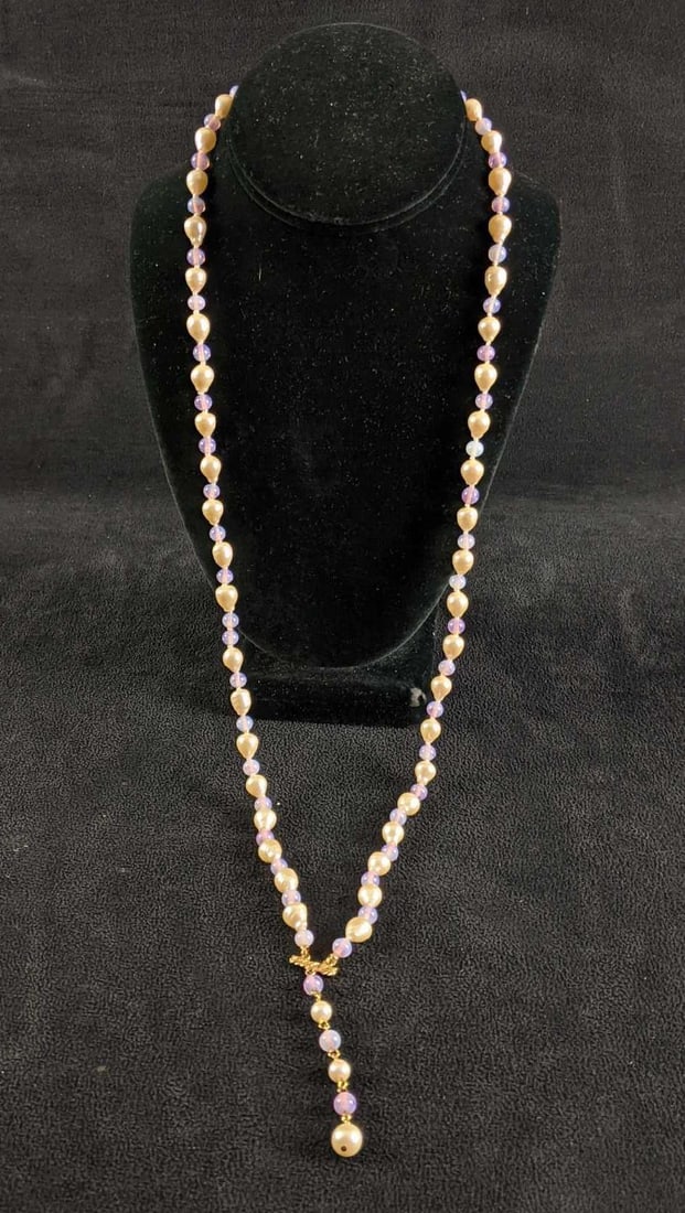 River Pearl and Glass Beaded Necklace: River Pearl and Glass Beaded Necklace This necklace is in good condition. There is no known damage. This necklace does not have a clasp it is big enough to go on over one's head.