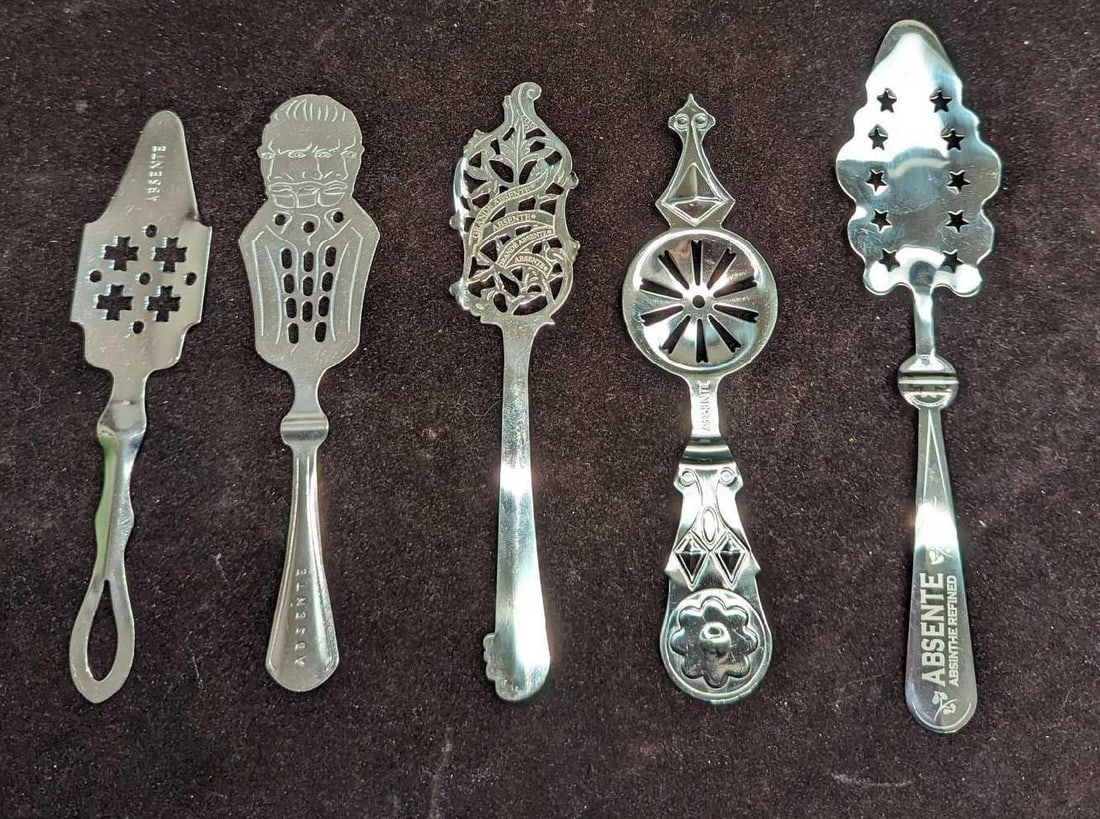5 Metal Absinthe Strainer Spoons H: 5 Metal Absinthe Strainer Spoons H. This lot includes: (1) Vincent Van Gogh Seeing Double Absinthe Strainer Spoon. This is approx 1 1/2" x 6 1/4". (1) Absinthe Spoon. This metal spoon is appro