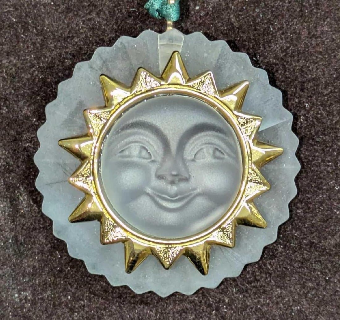 Retired Swarovski Christmas Memories Sun Ornament: Retired Swarovski Christmas Memories Sun Ornament. This comes with the original box that is approx 4" x 1 1/4" x 4" and it weighs 0.23lb. The ornament has no chips or cracks. The box has some shelf we