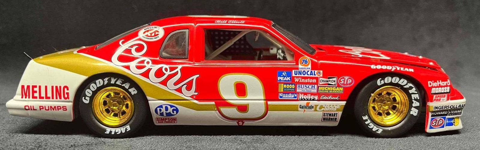 1987 Bill Elliott Coors Historical Series Die Cast Car: This lot contains a 1987 Bill Elliott Coors Historical Series Die Cast Car. It is approx 8 1/4" x 2 3/4" x 2" and weighs about 1.2lbs. Overall the Die Cast Car is in good used condition with some ligh