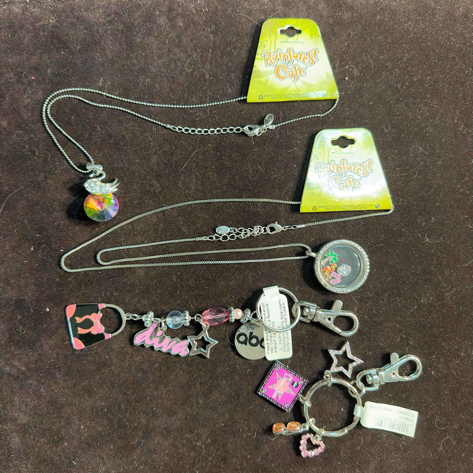 Disney ABC Keychains and Rain Forrest Cafe Necklaces Lot of Four: Disney ABC Keychains and Rain Forrest Cafe Necklaces Lot of Four. This lot includes like new two ABC keychains and two Rain Forrest Cafe necklaces. These items are in good pre-owned, previously displa