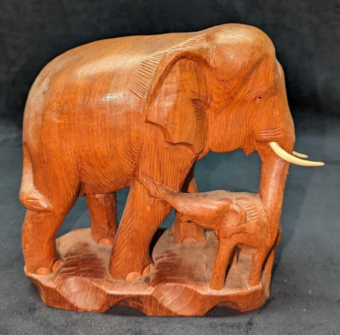 Vintage Teak Wood Carved Elephant With Baby Figurine: Vintage Teak Wood Carved Elephant With Baby Figurine. This is approx 9 1/2" x 4" x 10" and it weighs 3.89 lbs. There is some light wear on the figurine.